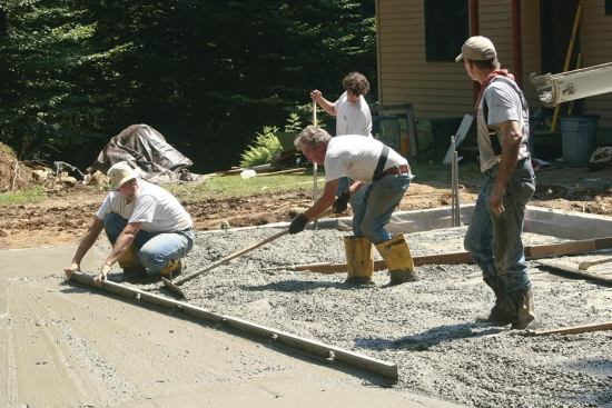 Rakes, shovels, and “come-alongs” are used to move concrete into the forms and ahead of the screed.