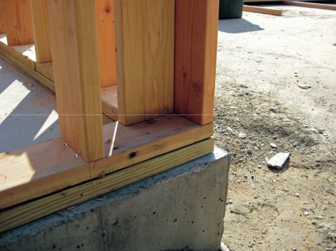 We decided to set the foam sill seal and PT 2x6 mudsills back 1 1/2 inches off the edge of the concrete