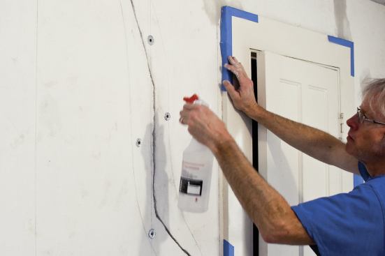 To repair a crack in solid plaster, first mist it with water to prevent the patching compound from drying out too quickly.