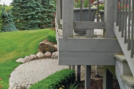 Water and debris that collect behind the fascia board can eventually cause it to pull away from the deck. Here the fascia has rippled and deformed at its top edge.

