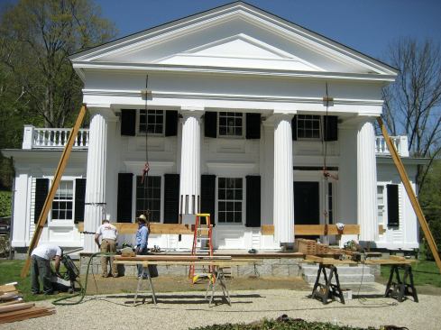 The cantilevered portico was braced to prevent sagging, and the columns were held in place in pairs using 2x12s rigged to come-alongs anchored to the pediment above.
