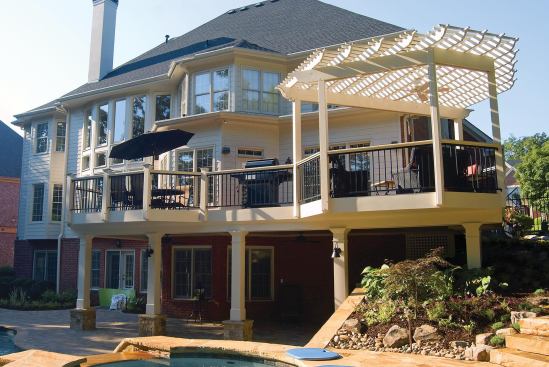 Bolting the posts to the framing provides a great deal of rigidity. With freestanding arbors, more bracing may be needed — in the form of knee braces or, as in the photo, triangular shapes made by the lath, joists, and beams.