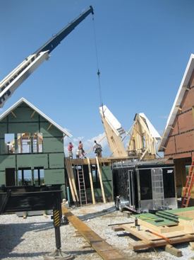 A crane was used to lift into place the panelized second-floor walls, including two rake walls with prefabricated eaves ...