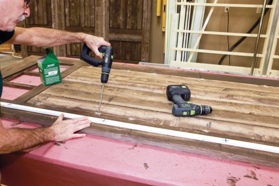 While fastening the panels to the frames, the author used his story pole to avoid placing screws where the doors would be cut.