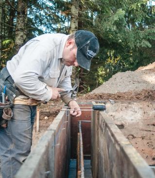A reference line snapped within the top inch or two of the forms indicates the elevation of the top of the wall. The author tacks a 3d finish nail every 12 to 16 inches along the snapped lines to make them easier to find during the pour.