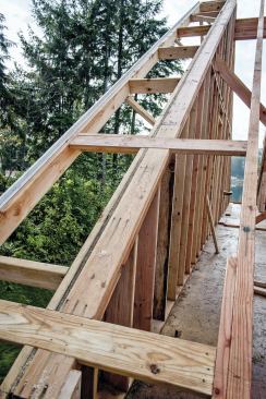 On any roof (I-joists or sawn lumber), we speed things up by framing the gables on the ground as rake walls, with the overhangs preinstalled, and then lifting the assembly into place.