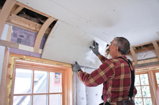 When forming the panels, crewmembers worked slowly and avoided pushing hard on the center of the panel, which would break the paper face and buckle the drywall.