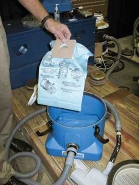 When debris enters a HEPA vacuum, it's captured in a collection bag – usually paper (above) but sometimes fleece (below). Fleece bags cost more but are tougher and can be filled more completely without a loss of suction.