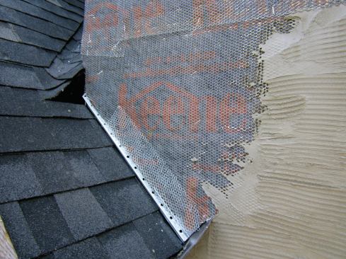 The weep screed was followed by housewrap, black paper, rainscreen mat, and lath, all terminating to a weep screed at the roofline before applying the scratch coat.
