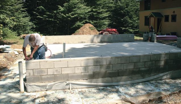 The framed garage walls are supported on an 8-inch block knee wall.