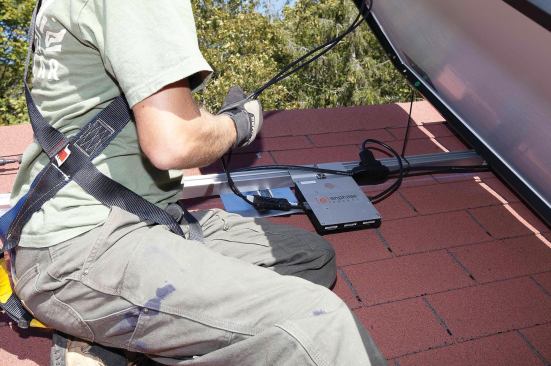 Cables are zip-tied to the rails or module frames as needed to prevent them from rubbing against the shingles or trapping debris.