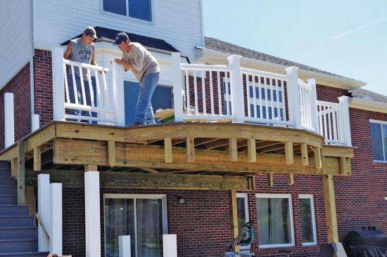 To support the fascia, blocking made from pairs of offcut 2x4s is installed approximately every 2 feet, and as needed to accommodate the shape of the deck. The longer leg of each 2x4 pair is fastened to the perimeter joist from behind so that the shorter leg aligns with the joist face.