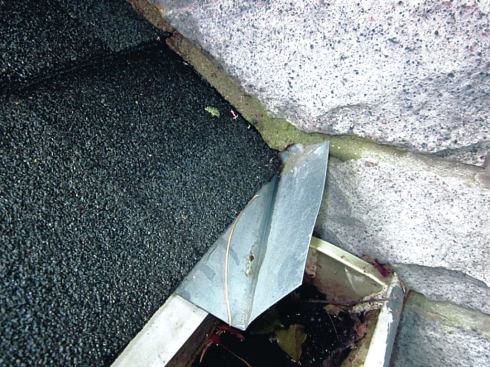On this particular house, we found some attempt to install kick-out flashing above the gutters on roofs intersecting sidewalls. The kick-out shown had probably been installed after-the-fact, and it was much too little, much too late.