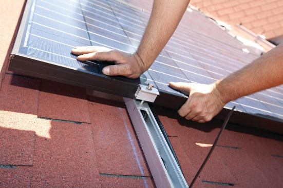 Another set of mounting clips is positioned against the outside edge of the module frame, and the sequence is repeated for the next module.