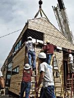 The home incorporates regional materials like cypress siding. Here, the students practice roof disassembly in preparation for the model’s trip to the Capitol.