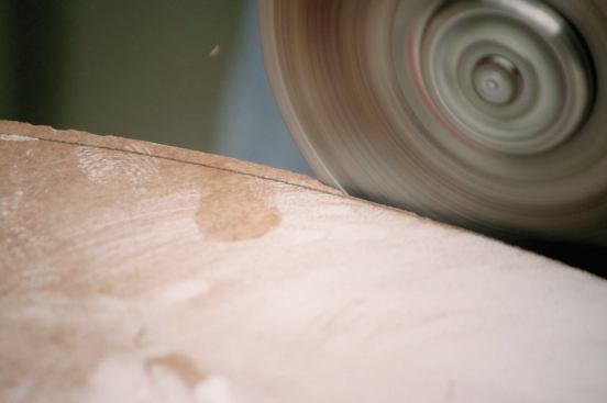 ANGLE GRINDER WITH 

A DIAMOND BLADE

Some shapes are just too impractical to cut on a conventional wet saw or a small circular saw. For very large cuts — such as the curve made on the 24-inch porcelain tile shown here — I use an angle grinder with a dry-cutting diamond blade. This is also what I use to cut through tiles and grout when I am ripping out an old installation. (I can use the grinder for cutting galvanized lath, rebar, and other materials, too, simply by switching to a wheel for cutting metal.) 

When using the grinder to cut a tile — especially if the cut will show — I use a four-step process. First, I rough out the desired shape until the blade is 1/8 inch to 1/4 inch from the cut line (21). Next I cut away excess material until the blade is about 1/32 inch from the line. Then 

I cut exactly to the line (22). For the last step I use a tile rubbing stone or a belt sander (see photo 29, 

page 47) to smooth the cut and make a small finishing bevel.