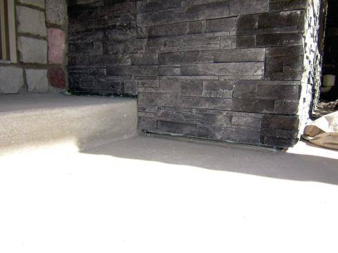 Lath and the scratch coat will go over the rainscreen mat, followed by mortar and stone.