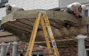 Figure 1. The mitered band board is first assembled and then installed as a unit. Blocks screwed to the bottom of the joists hold the band board in place while it's being installed. Note the doubling of every other joist.