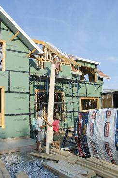 LSLs are a lot heavier than I-joists or sawn lumber; wrestling the 20-foot-long common rafters into position was a three-man job.