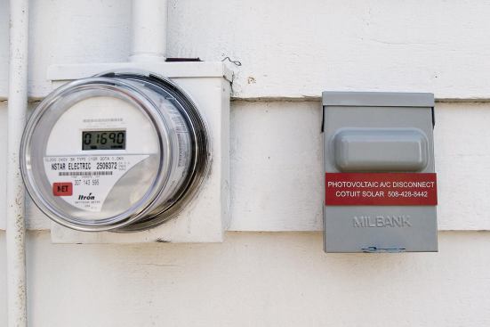 A second meter on the outside wall registers the homeowner’s net power use, spinning forward or backward depending on whether the home is drawing power from the grid or supplying it. If more power is produced than used, there’s no electric bill that month. A utility-required emergency shutoff switch allows utility workers to confirm that the panels are offline when needed.