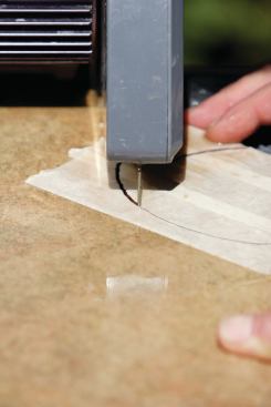 RING SAWS

There are several ring saws on the market that offer an alternative to freehand cutting. The same diamonds found on regular wet-saw blades are bonded to a hardened circular steel band or rod that cuts in the same way as a carpenter’s band saw (18). Like the blades on other types of diamond saws, the ring saw’s blade must be bathed in water, but rather than being sprayed with spouts or nozzles, it passes through a bath of water located below the cutting table. Some ring saws can cut porcelain tile and granite, but in my opinion, they are not well-suited for production cutting of these materials. I use a ring saw when I need to make a large number of irregular cuts in relatively soft materials, but for most irregular cutting, I prefer to use a conventional wet saw.