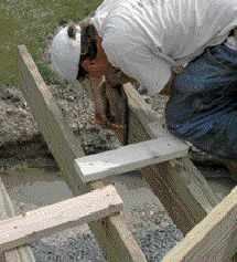 Figure 5. Mark the cut lines square down from the tops of the joists. The bevel angle for the saw is measured with a speed square from the marks atop the joists.