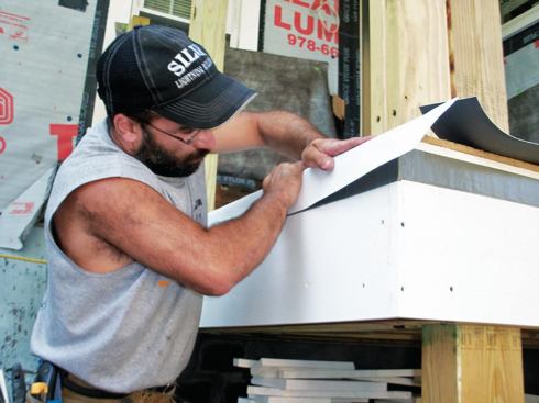 Turned-down membrane edges are secured to the PVC fascia with double-sided tape approved by the TPO manufacturer.