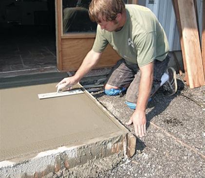 When the slab is hard enough that a trowel won’t dig in, it’s steel troweled to compact the surface.