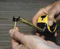 Figure 6. Curved shims are screwed to the band board to support a curved fascia (top). A tape measure hooked on the head of a screw (bottom) set at the center point is used to lay out the curve on one piece of 2-by, which is cut out carefully and used as a template for the rest.