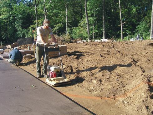 Segmental retaining walls don’t require a concrete footing but do require a solid base of compacted crushed rock.