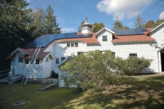 Layout of the 9.3-kw array (two additional PV modules lie on the far side of the larger gable dormer at right) was based on a thorough shading analysis of the site. Because the structure faces southwest, it receives full sun relatively early in the day for much of the year, but is subject to some late-afternoon shade. (Several trees to the west of the array were later removed to eliminate some shading.)