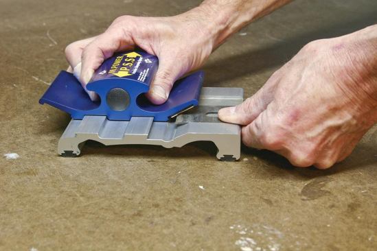 To sharpen a plane blade or chisel with the PSS1, you simply place it on the base and run a diamond stone housed in the carriage back and forth over it.