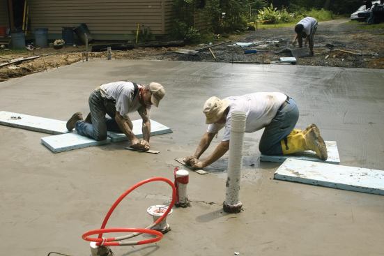 Knee boards (here made of rigid foam, but usually of plywood) keep workers from sinking in the center of a large slab.