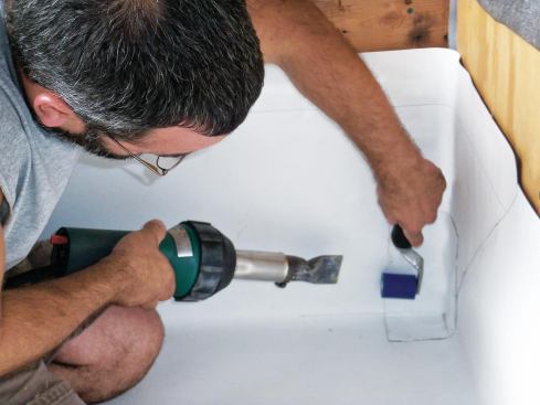 A prefabricated corner piece is heat-welded to all three surfaces.