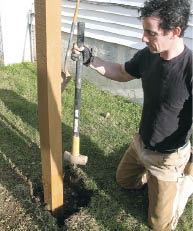 Figure 3. The bottoms of the posts rest on gravel for drainage and are topped with a bag of quick-setting concrete to keep them steady. Tamping the soil adds more stability and minimizes setting.