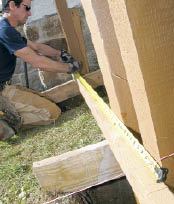 Figure 4. The author lays out the post locations on a 2-by that will also be used to align and brace the tops of posts.