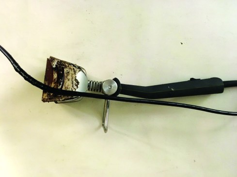 The new, compact Speedheater Cobra is designed for smaller surfaces. The heating element does not get as hot as a torch or heat gun, but caution still applies. Electrical tape on the power cord and melted portions of the metal shroud clearly show the need to be careful when setting the tool aside during use.
