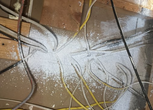 Once the big holes were stuffed, the 22 wires above a sub-panel took about a minute to seal.