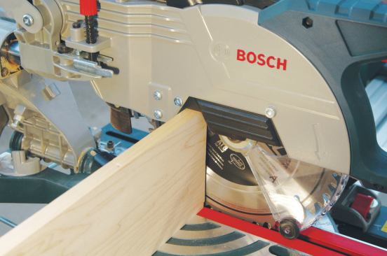 A notch in the blade housing of this Bosch miter saw provides a little extra capacity for stock that is cut vertically against the fence.