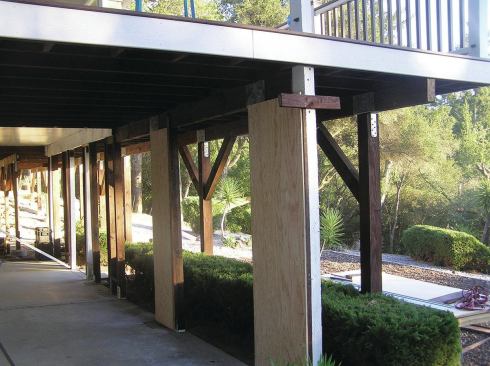 This unusual project required retrofitted posts tied to the existing posts with plywood sheathing.