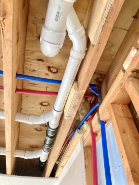 New supply lines tied into the existing copper with press fittings. Note the ABS vent connection using Fernco fittings with rubber sleeves and hose clamps. 