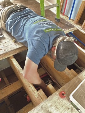 A press tool was essential for joining new PEX to existing copper in tight framing bays.