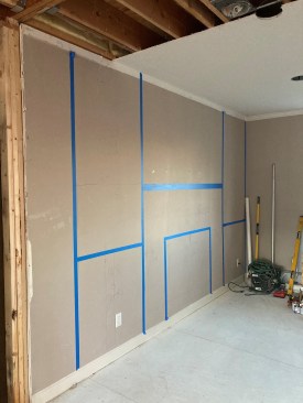 To help the clients visualize the new fireplace wall, the author taped out the layout to scale. 