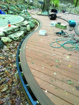 Then they installed the field decking with hidden fasteners, tracing the curved border onto the decking and cutting it in place.