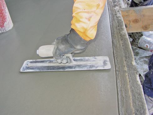 Similar to floating, keep the trowel blade flat as possible for initial troweling. As the concrete hardens, progressively increase the angle of the trowel blade to increase the pressure on the surface of the concrete.