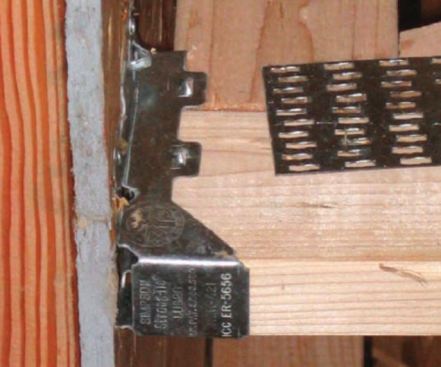 The gap at the end of this floor truss is a framing violation. Any truss or joist must have full bearing on the hanger seat. (photo: Jim Mattison)
