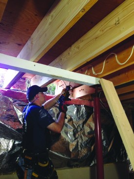 He then applied construction adhesive to the old joists.