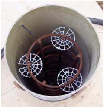 Plastic spacers centered the rebar in the tube; note the smooth, reflective surface of the form’s inner surface.
