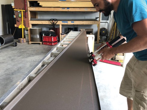 After one of the sections with two female legs had been slit into two pie-shaped pieces, a worker used a roll bender to hand-form first the 1-inch vertical leg