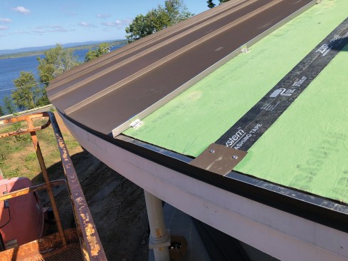 Workers used Prefalz coil stock to fabricate cleats to hold the drip edge in place along the eaves